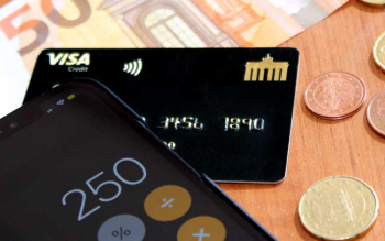 Taschenrechner und Geld mit der Deutschland-Kreditkarte